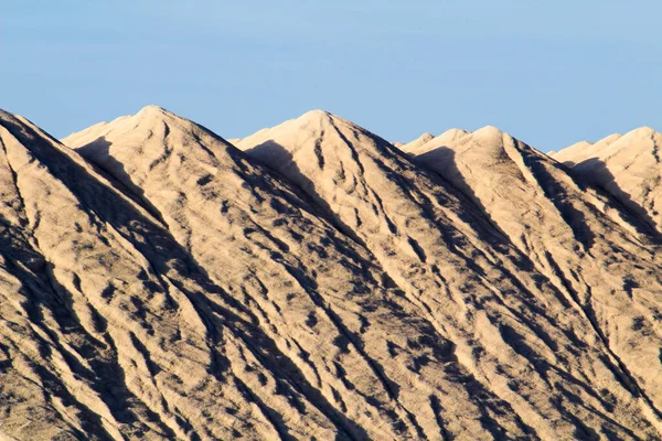 Salt mountains under blue sky in Santa Pola, Spain