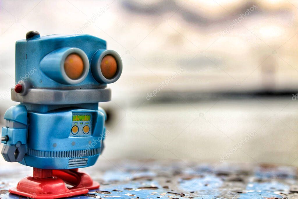 Toy robot on the banks of the Tagus River in Lisbon in a Cloudy day