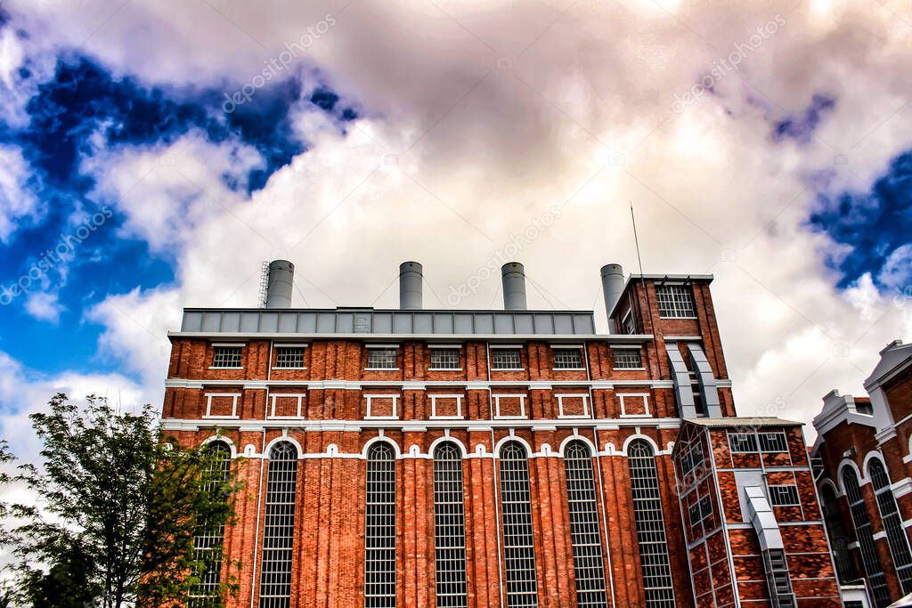 Facade of the electricity museum building in Lisbon under cloudy sky