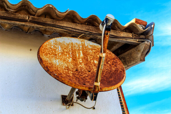 Old satellite dish in a house in Spain