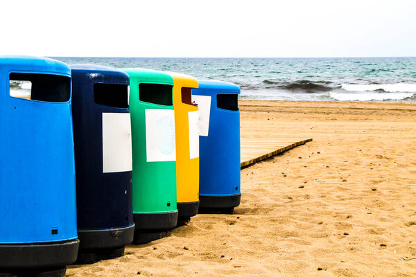 Colorful Wastebaskets and walkway to the beach in the morning