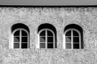 İspanya 'da beton cephede üç kemerli pencere. Tek renkli resim.