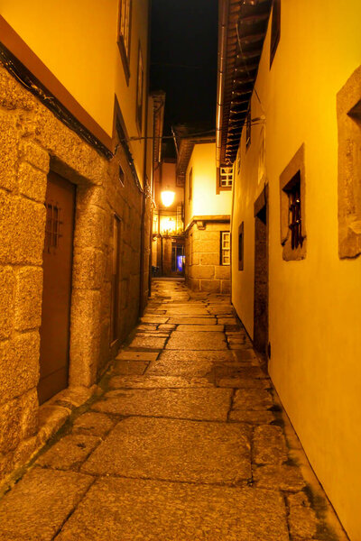 Beautiful streets and old stone facades of the portuguese medieval village of Guimaraes at night