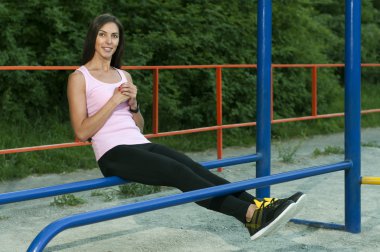 Woman has a rest on parallel bars