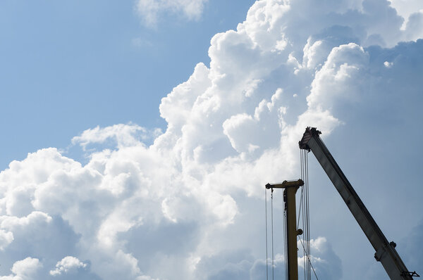The crane against a picturesque cloud