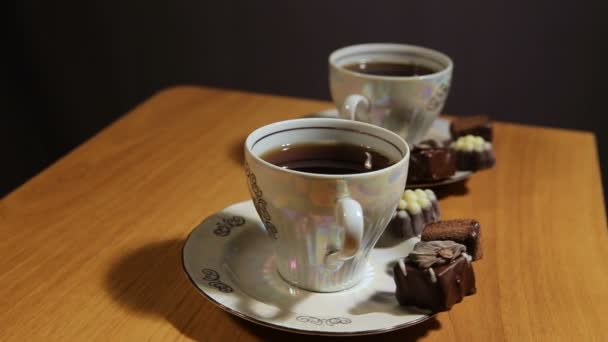 Tea set on the table with chocolate candy. — Stock Video