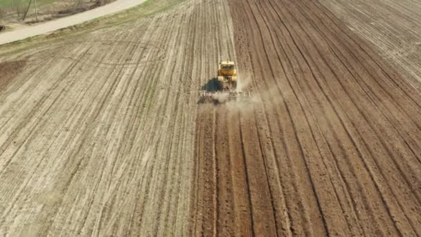 Traktor med tallrikshängare på åkermarken — Stockvideo