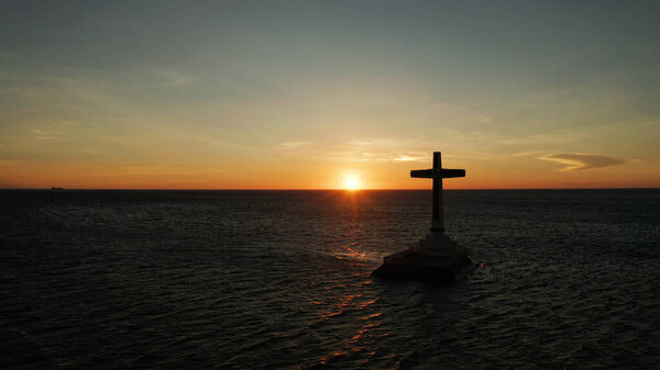 Sunken Cemetery cross in Camiguin island, Philippines.