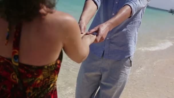 Paar lopen samen langs het strand — Stockvideo