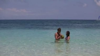 Mutlu çift Hindistan cevizi ile sahilde