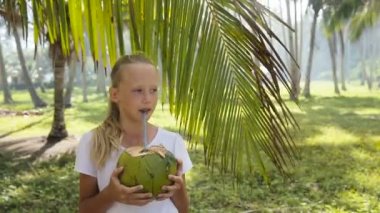 Young girl drinking coconut juice