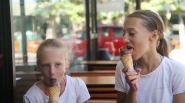 Young girls eating ice cream outdoors