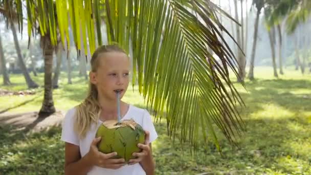 Young girl drinking coconut juice — Stok video