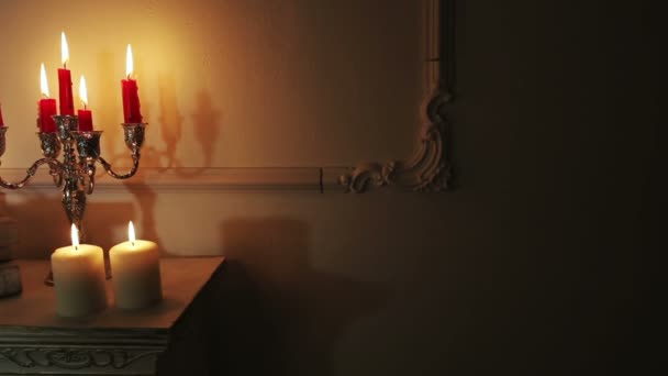 Old vintage books with candles in candlestick. — Stock Video