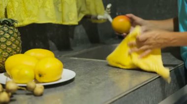 Woman wiping towel fruit