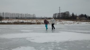Young girlsice skating on frozen lake