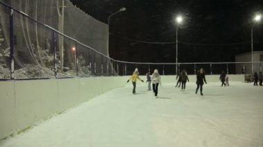 Young girl on ice skating at the rink