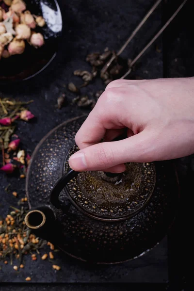 Variety of dry tea with teapot