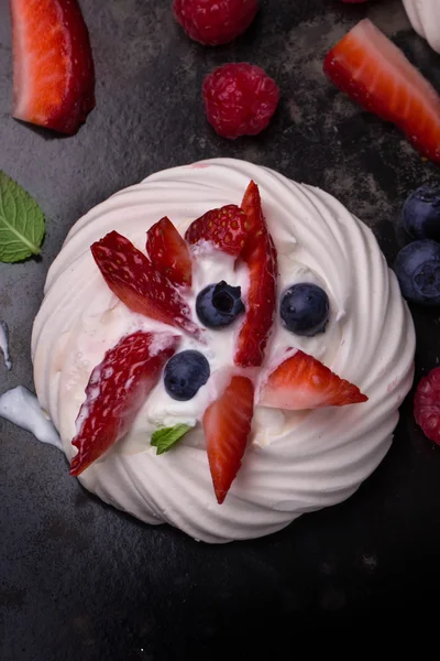 Pavlova berry cake with blueberries, strawberries and rasberries