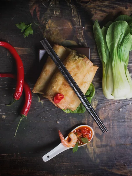 Fried spring rolls with  shrimps, bok choi, chili pepper and hot