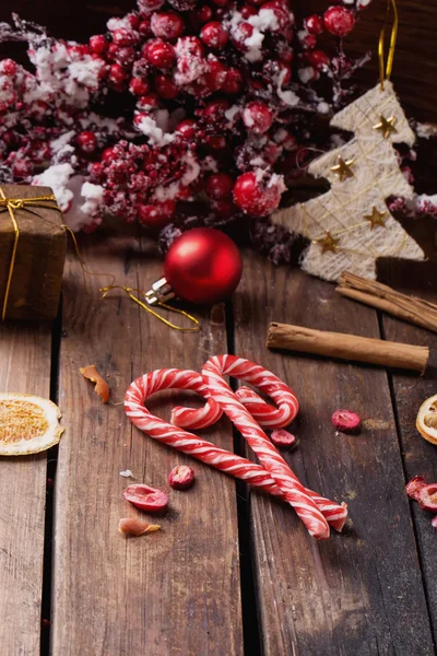 Christmas candies on rustic wooden board — Stock Photo, Image