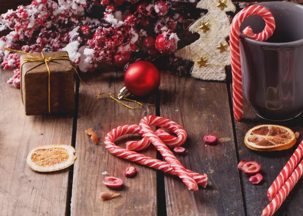 Christmas candies on rustic wooden board — Stock Photo, Image