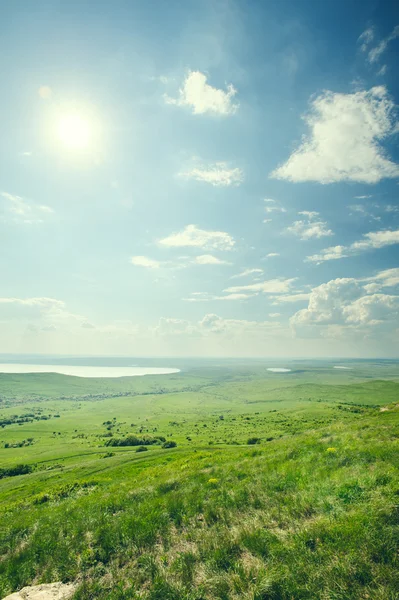 Photo of beautiful landscape with grassy land under sunny skies