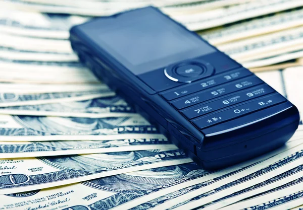 Mobile Phone On The Money Background Stock Photo