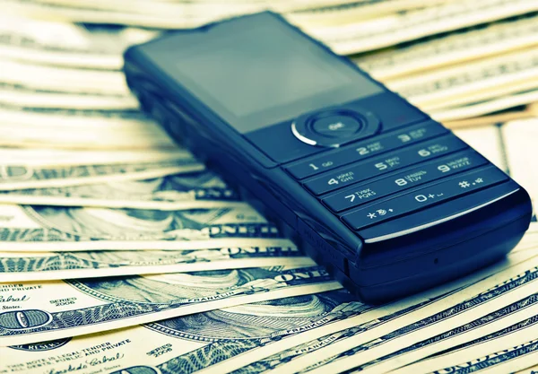 Mobile phone on the money Stock Image