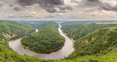 panorama view the river Saar in Germany, with a ferry boat passing through