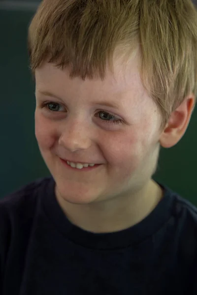 Smiling blonde boy looking to the left — Stock Photo, Image