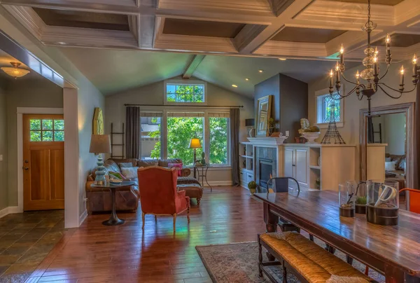 Dining and living room area with coffered ceilings