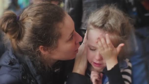 Mom Kisses a Kid Forehead Kiss Girl Stops Crying Mom is Going to Lead a Girl Away Little Girl is Very Upset Talking Something Mom is Comforting the Daughter — Stock Video