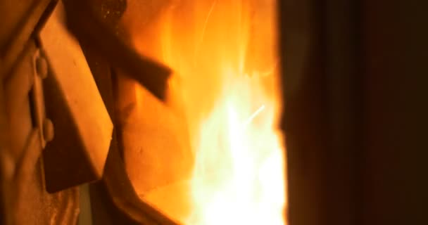 Leuchtend rotes Feuer brennt hinter der Ofentür — Stockvideo