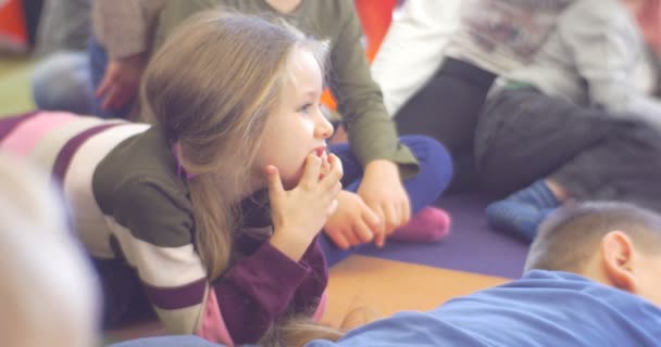 Les enfants reposent sur un tapis doux dans un jardin d'enfants — Video