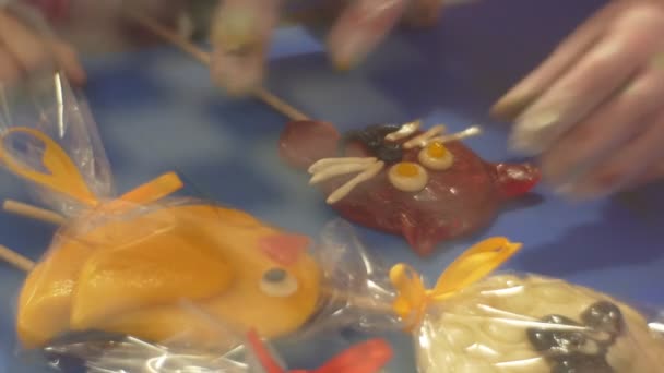 Kid and Teacher Decorating a Cat Shaped Candy Learning to Make Sweets Excursion to Sweets Factory Caramel on a Stick Confectioner is Teaching the Kid — Stock Video