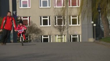 Çalışan boyunca kızı gülen çocuk sürme Bisiklet baba ile kızı uçurtma zaman bir bisiklet dümen güneşli gün bahar üzerinde sabit harcıyor babasıdır