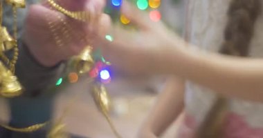 Kız ile Her baba veya büyükbaba çöz dolaşmış Garland altın çan önce koyarak yeni yıl ağacı çam renkli Lamplights aile kutlama için