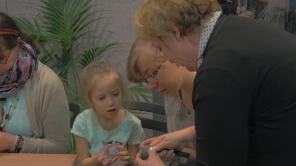 Women Are doing Easter Eggs at Family Master Class Opole Women Are Cutting Out an Ornament Kid is Looking Preparing to Easter Celebration Families Together — Stok Video