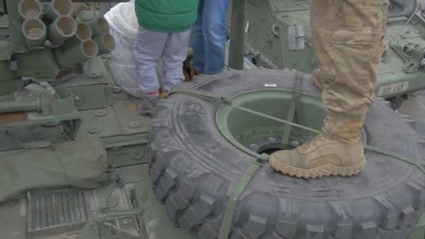 Kinder kommen in die Kabine des Panzer-Nato-Betriebs in Oppeln Soldaten unterhalten die Kinder, die sich um Kinder kümmern Militärstiefelparade auf einem Platz — Stockvideo