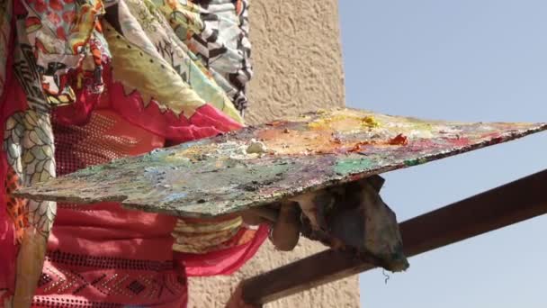 A Woman in Bright Dress Draws Pictures on a terrace — Stock Video