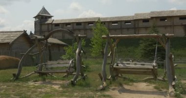 Wooden Log Swings are Swinging, Ancient City Wall on Background