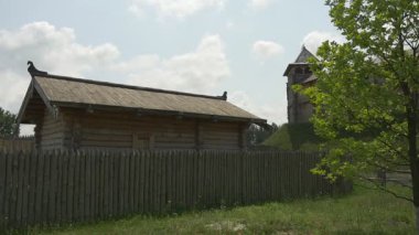 Wooden Ancient House Behind The Log Fence, Watchtower on the Hill