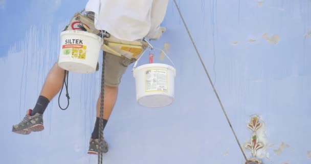 Man's Legs, Restorer is Holding on a Rope, Putting Down The Brush Into Paint, Paints in a Buckets, Man is Painting the St. Michael's Cathedral — Stock Video