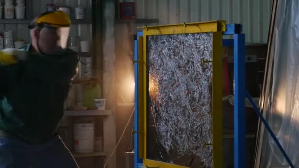 Worker in Uniform And Protective Screen is Beating the Glass Sheet by Hummer, Sheet of Glass is in Metal Frame, Cracks, Testing of Bulletproof Glass — Stock Video