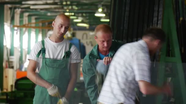 Due lavoratori in uniforme verde, mettere giù la lastra di vetro, L'uomo in civile si è avvicinato, Parlando con i lavoratori, Test di vetro antiproiettile — Video Stock