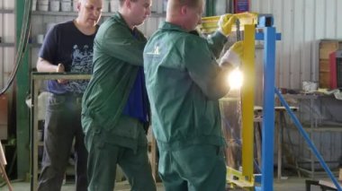 İki işçi ve sivil vardır kurulması, cam levha Metal Çerçeve, test kurşun geçirmez Cam, temperli cam kırılma içinde adam