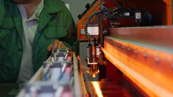 Worker is Looking Down Into The Machine, Talking, Light inside of Machine, Worker in Uniform at The Machine, Put The Sheet of Glass into Machine — Stock Video