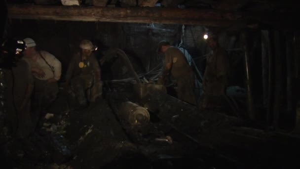 Four Workers Miners Men is Safety Helmets And Lamps on a Helmets Respirators Men are Working at the Mine — Stock Video