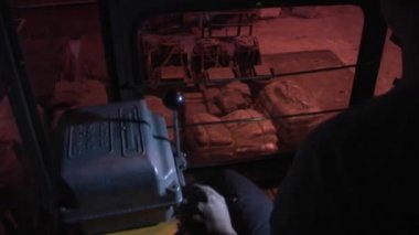 Woman Worker Woman's Back Hand on Lever Close Up Crane Driver in Cabin of Crane Factory through the Cabin Windows Top Down Crane is Moving